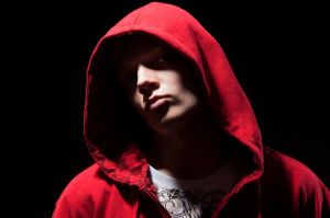 cool b-boy in red jacket against black background